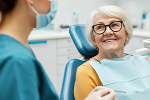 Senior patient talking with dental team member