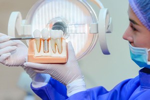 Dental team member explaining dental implants