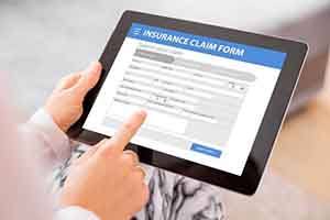 Insurance claim form displayed on electronic tablet