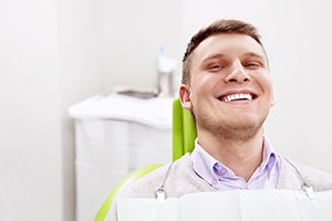 Happy man in dental treatment chair
