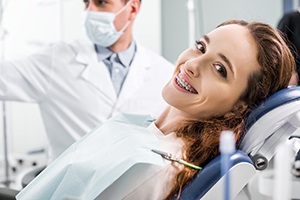 Dental patient with braces reclined in treatment chair